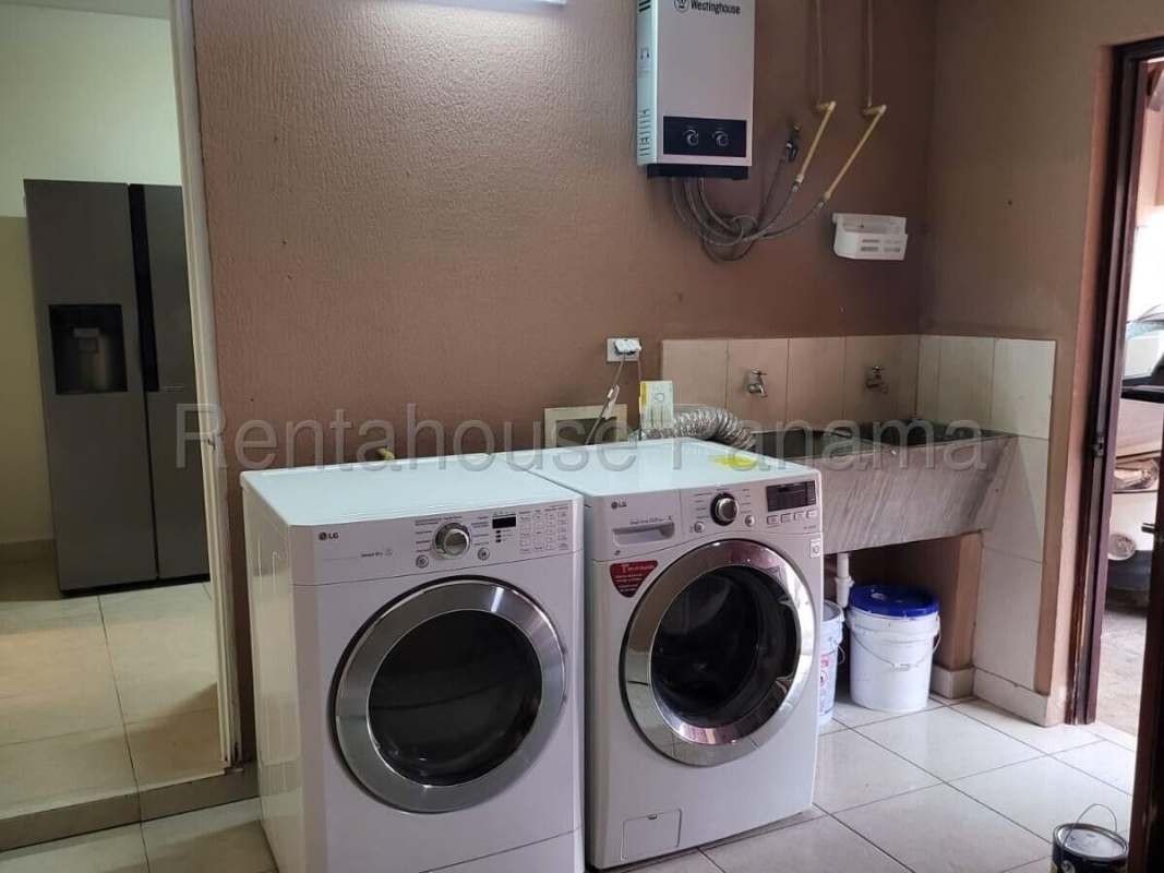 Laundry area with washer dryer hookups and water heater at Residencial Versalles Panama