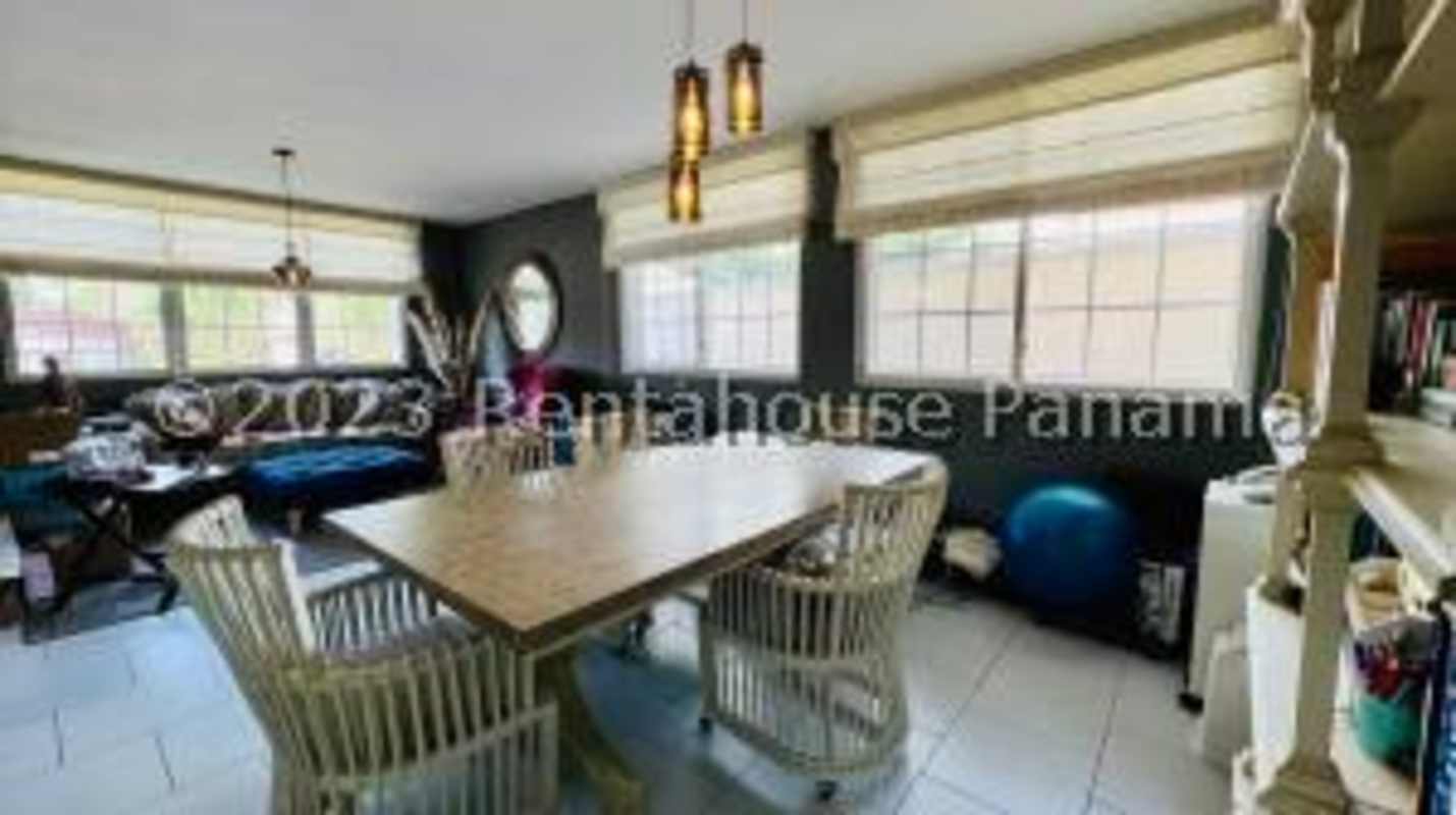 Spacious living room with large windows views to pool tiled floors luxury house Altos del Golf Panama