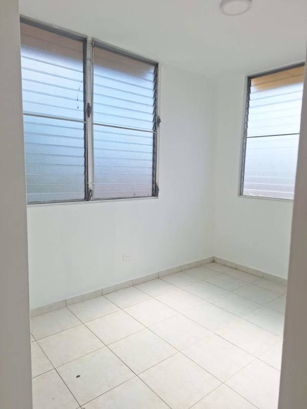 Compact kitchen with wooden cabinets floral backsplash Ave La Pulida Panama