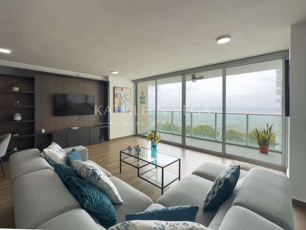 Contemporary furnished living room with ocean views and balcony access at PH Lumiere Costa del Este Panama