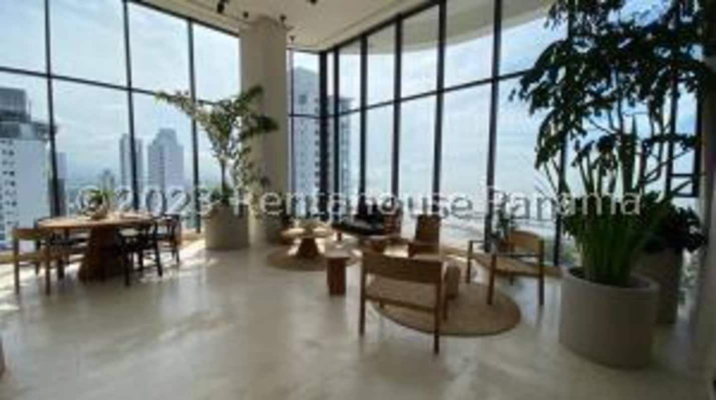 Bright living room with panoramic windows ocean skyline view in PH Victory Tower Coco del Mar