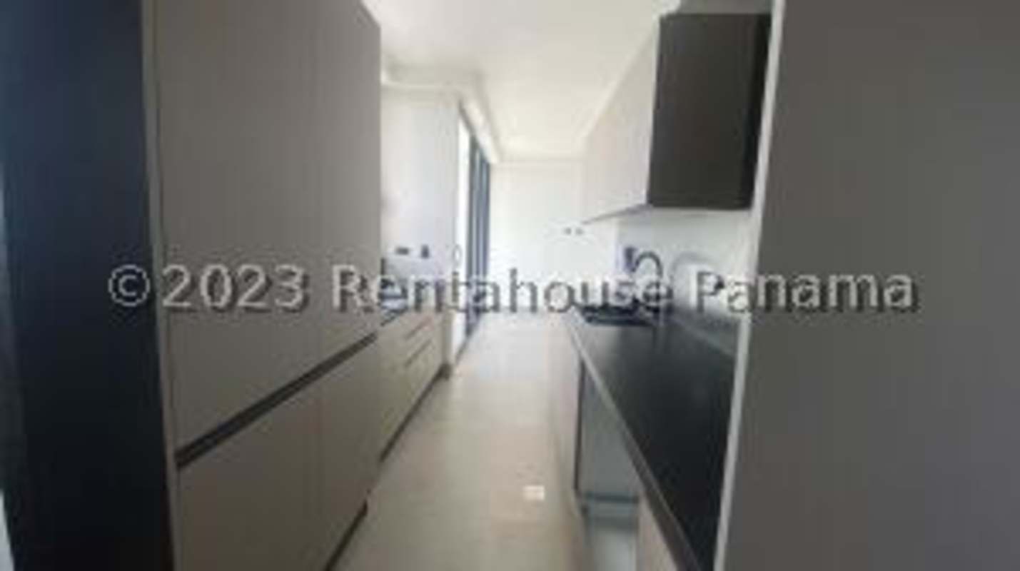 Galley kitchen with granite countertops and modern cabinetry rental apartment Coco del Mar