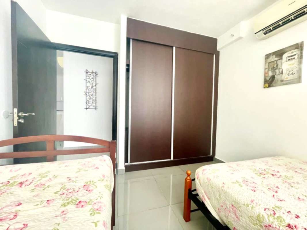 Contemporary kitchen with white cabinets, granite countertop and dining space PH Quartier Panama