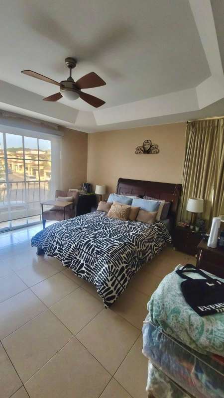 Bedroom with large glass door leading to balcony at Crystal Springs Condado del Rey house Panama