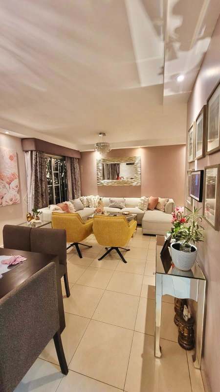 Living area with sectional sofa, modern lighting, large windows in Crystal Springs Condado del Rey house