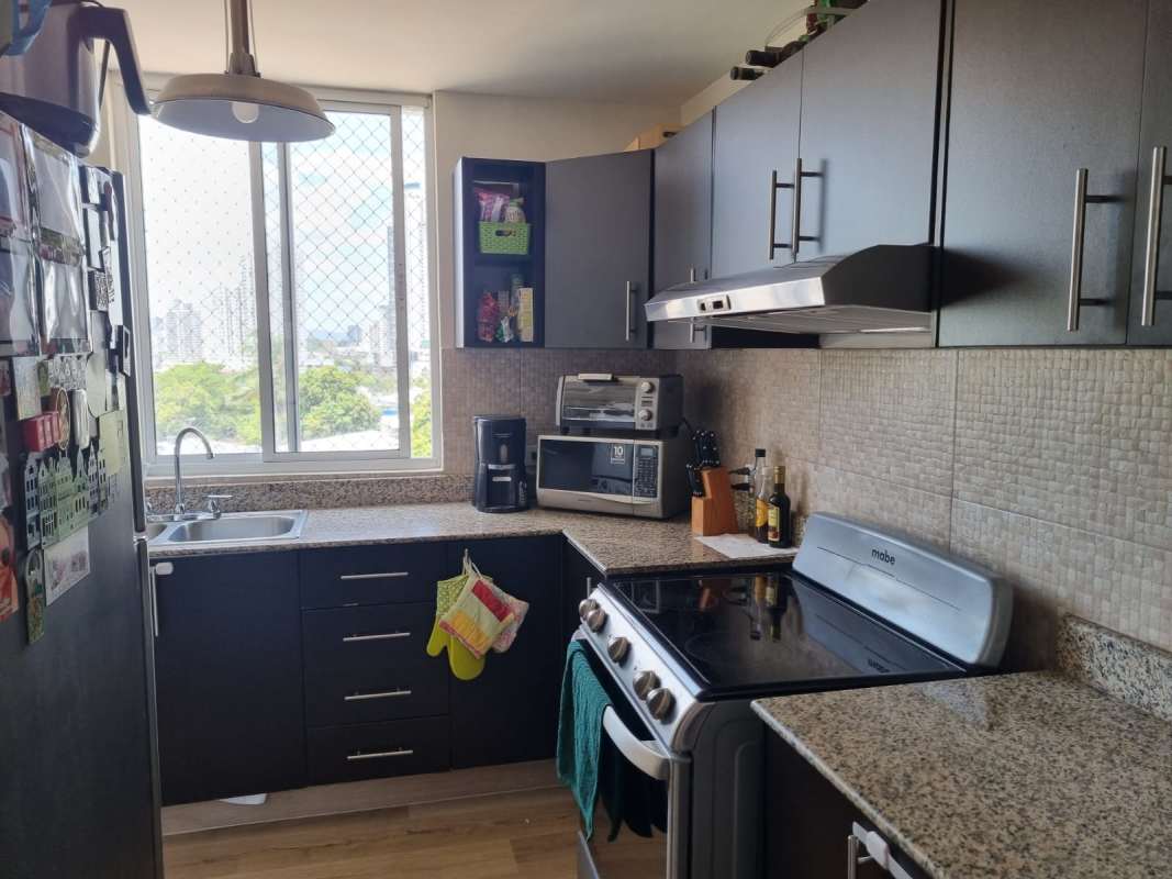 Kitchen with granite countertop, stainless steel stove, large window in Carrasquilla Park Tower Panama