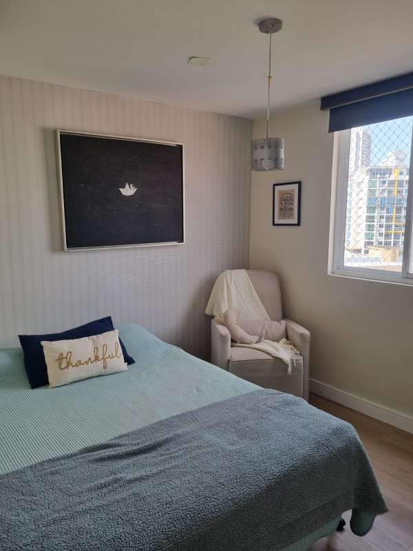 Small minimalist bedroom with AC, bookshelf, and natural light in Carrasquilla Panama apartment