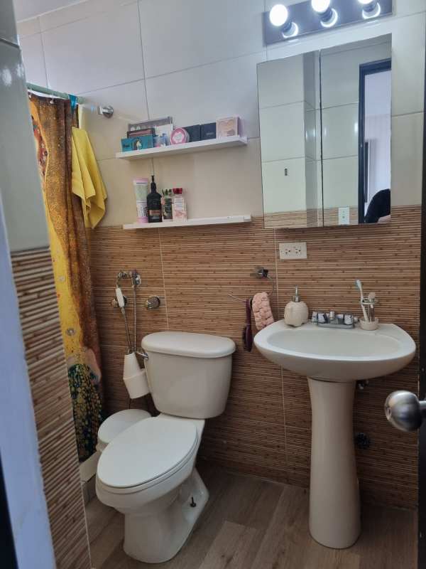 Bathroom with pedestal sink, mirror cabinet, and modern tile in Carrasquilla Panama