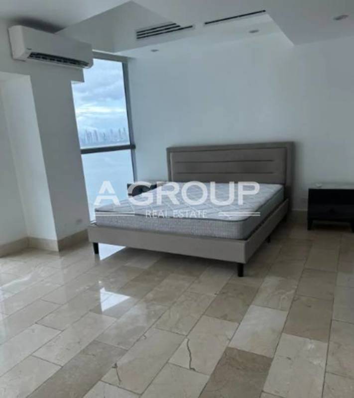 Bedroom with large window city skyline view in luxury duplex apartment PH Grand Tower