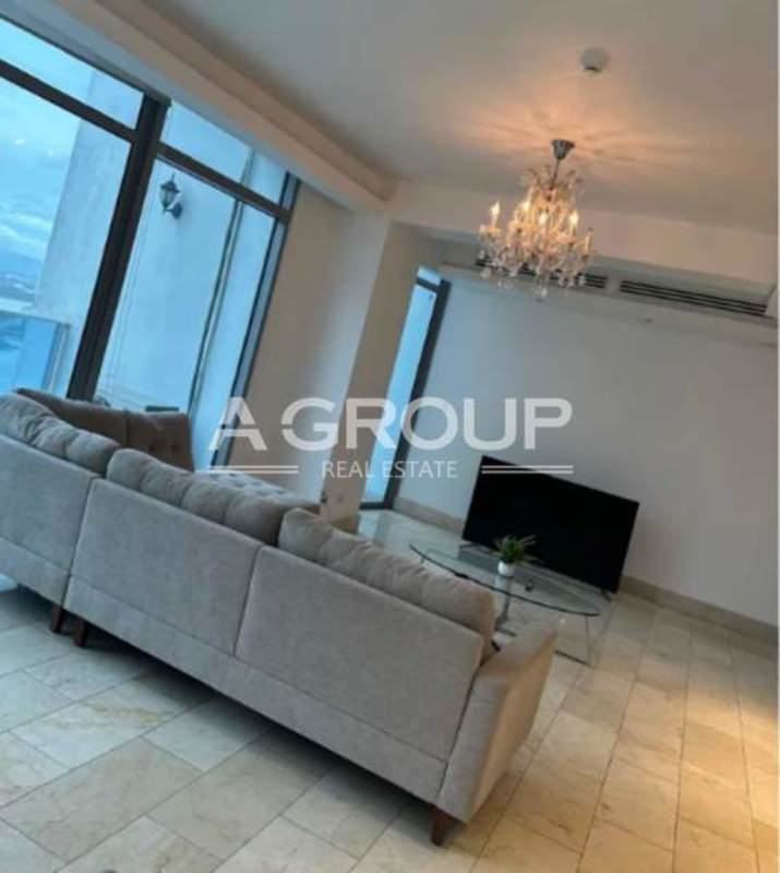 Spacious living room with large windows and ocean-city views at PH Grand Tower Punta Pacifica Panama