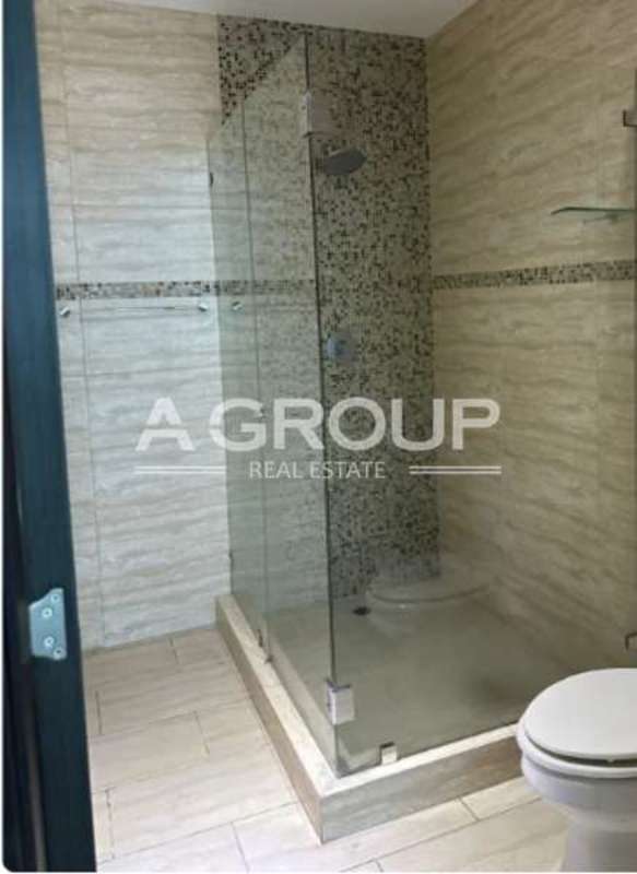 Modern walk-in closet with wood finishes in duplex apartment Punta Pacifica Grand Tower Panama City