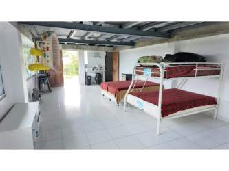 Flat green lot with various mature fruit trees at Villas Capisucia El Copecito San Carlos