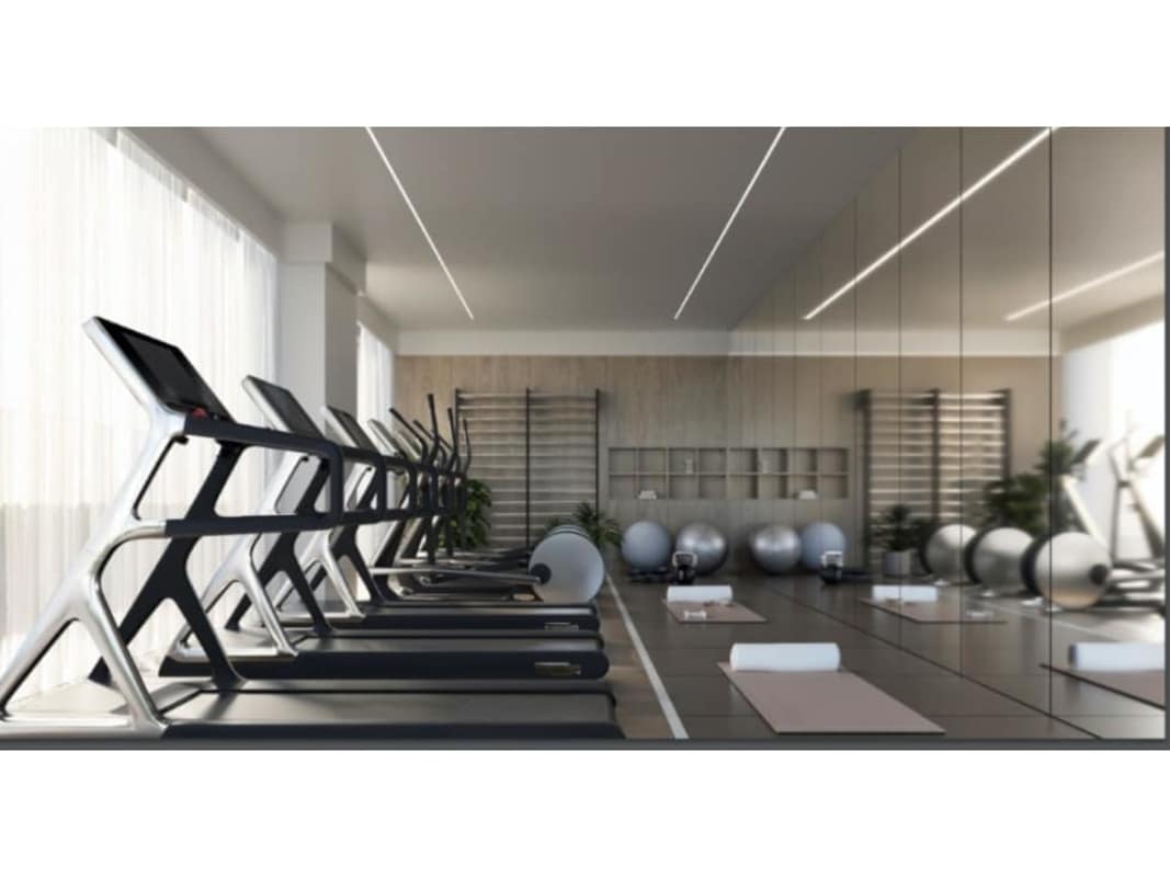 Indoor gym with city views and equipment at Kyte condos Obarrio Panama