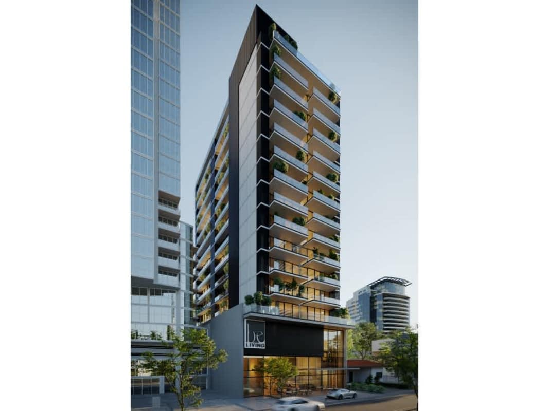 Modern compact kitchen with white quartz counter, black fixtures in Be Living condo San Francisco Panama