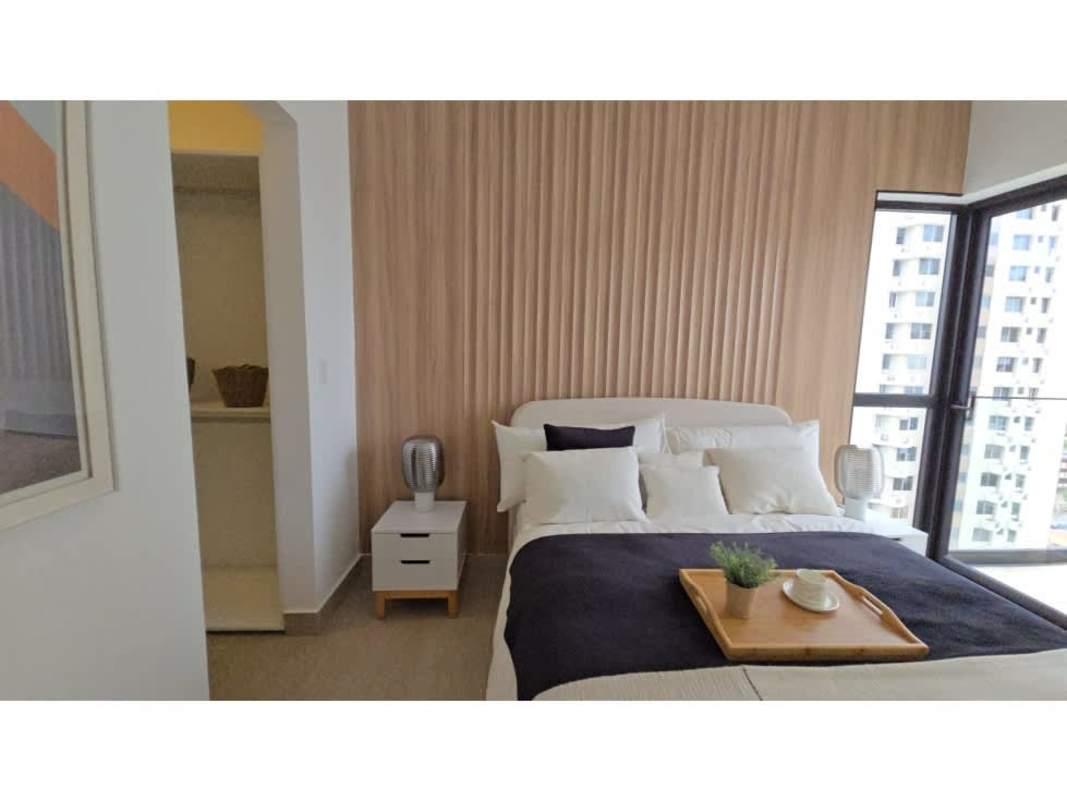 Minimalist bedroom with wood accent, walk-in closet, large window at PH Be Living Panama