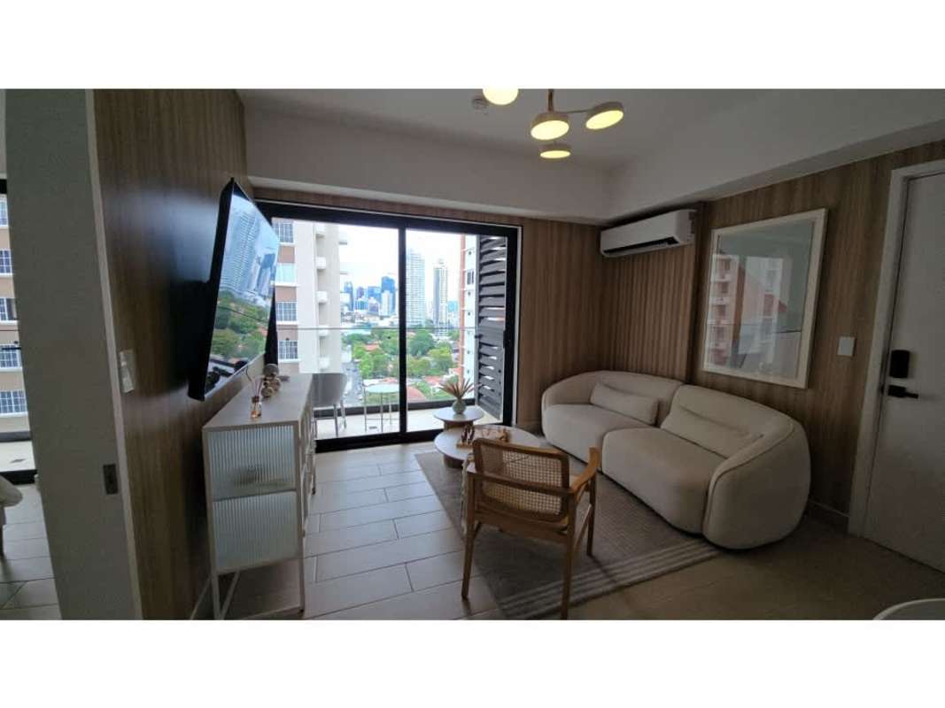 Modern living area with glass door, city view, neutral decor in PH Be Living condo