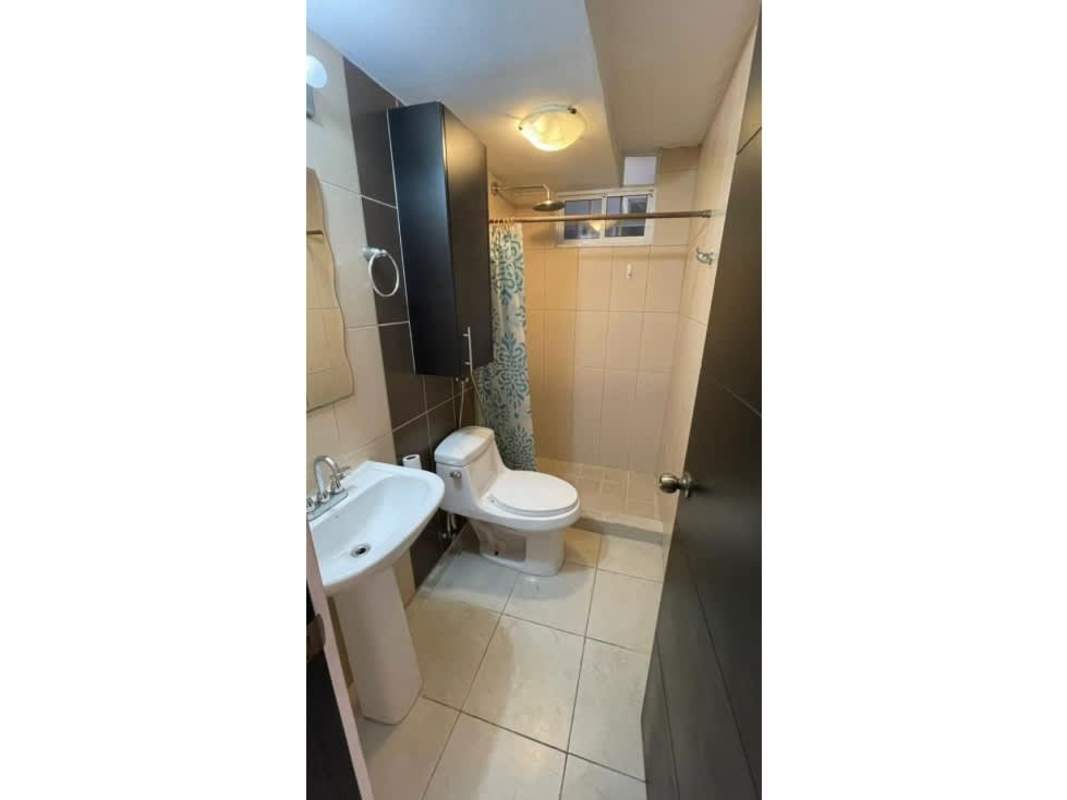 Compact bathroom with pedestal sink, shower with curtain, cabinet PH Vista Marina Panama