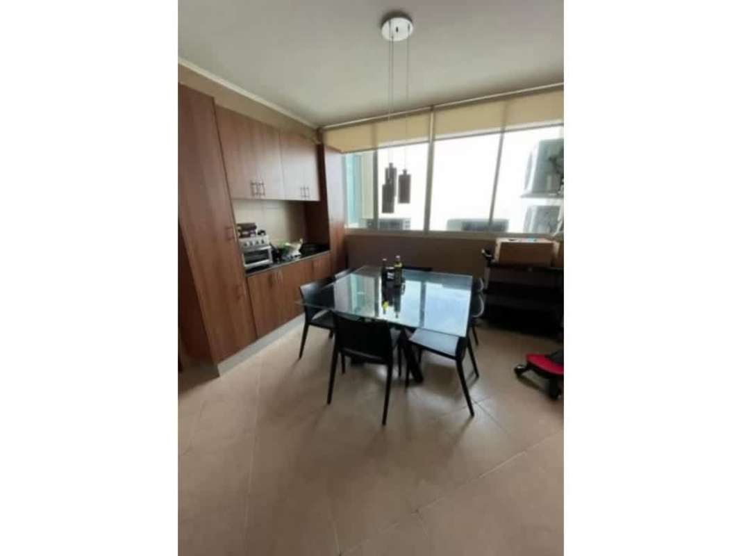 Dining room in luxury apartment with city skyline window views at PH Peninsula Punta Paitilla