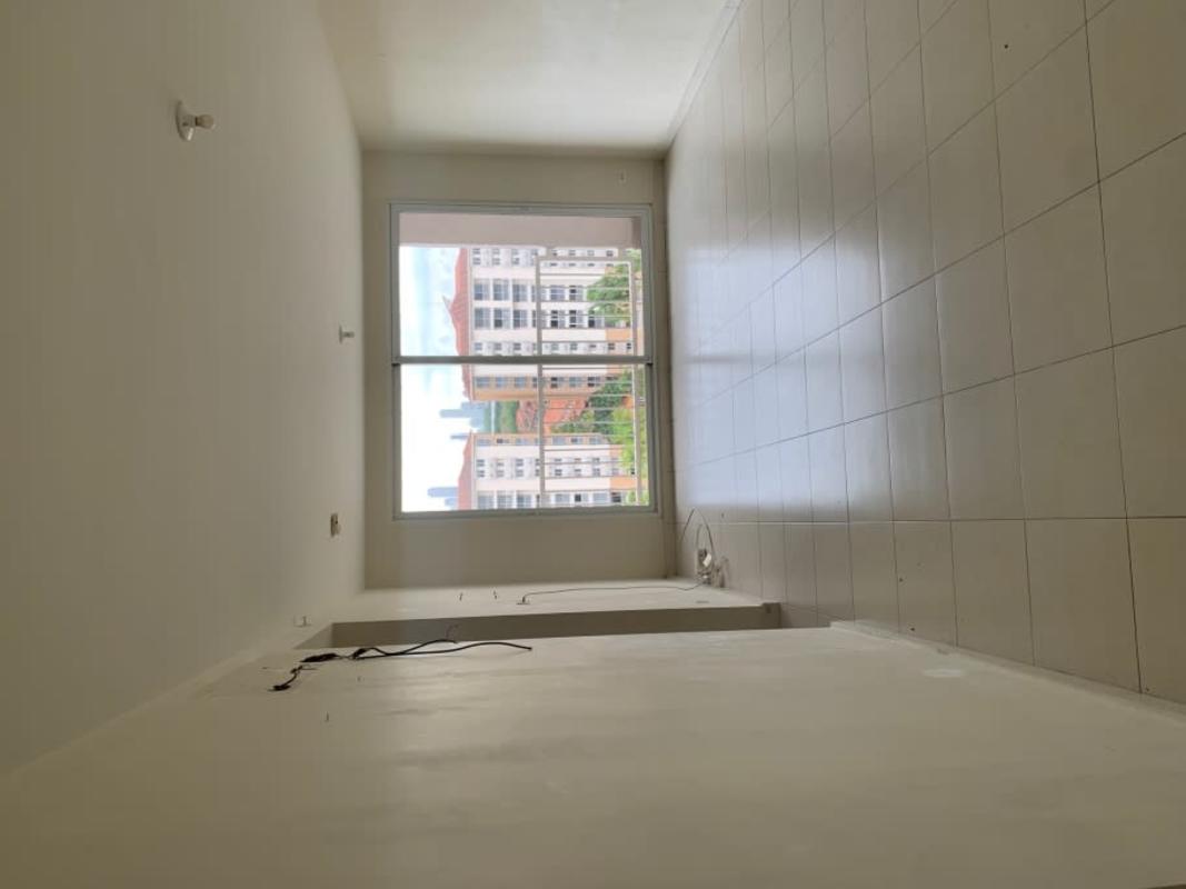 Apartment kitchen with granite countertop, gas cooktop, overhead cabinets and window PH Versalles Panama