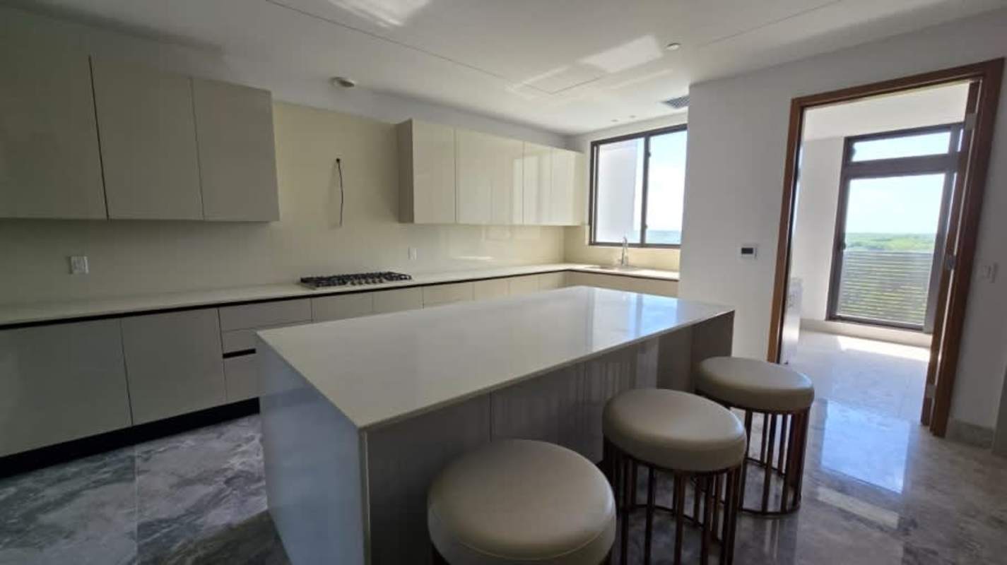 Gourmet Italian kitchen with island, quartz countertops, and elegant cabinetry in luxury condo Santa María Panama