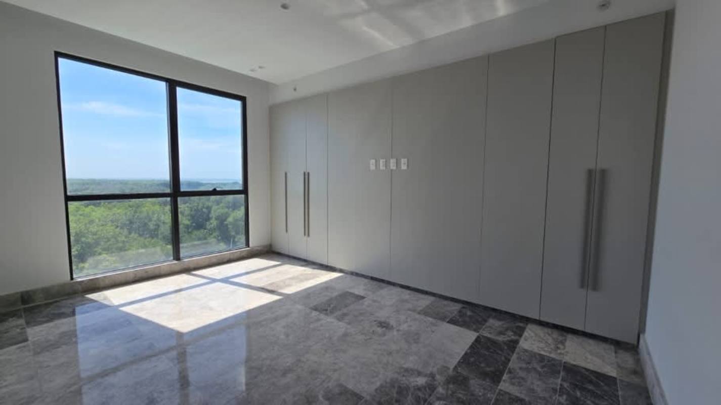Spacious modern walk-in closet with built-in shelving in luxury Santa María golf apartment