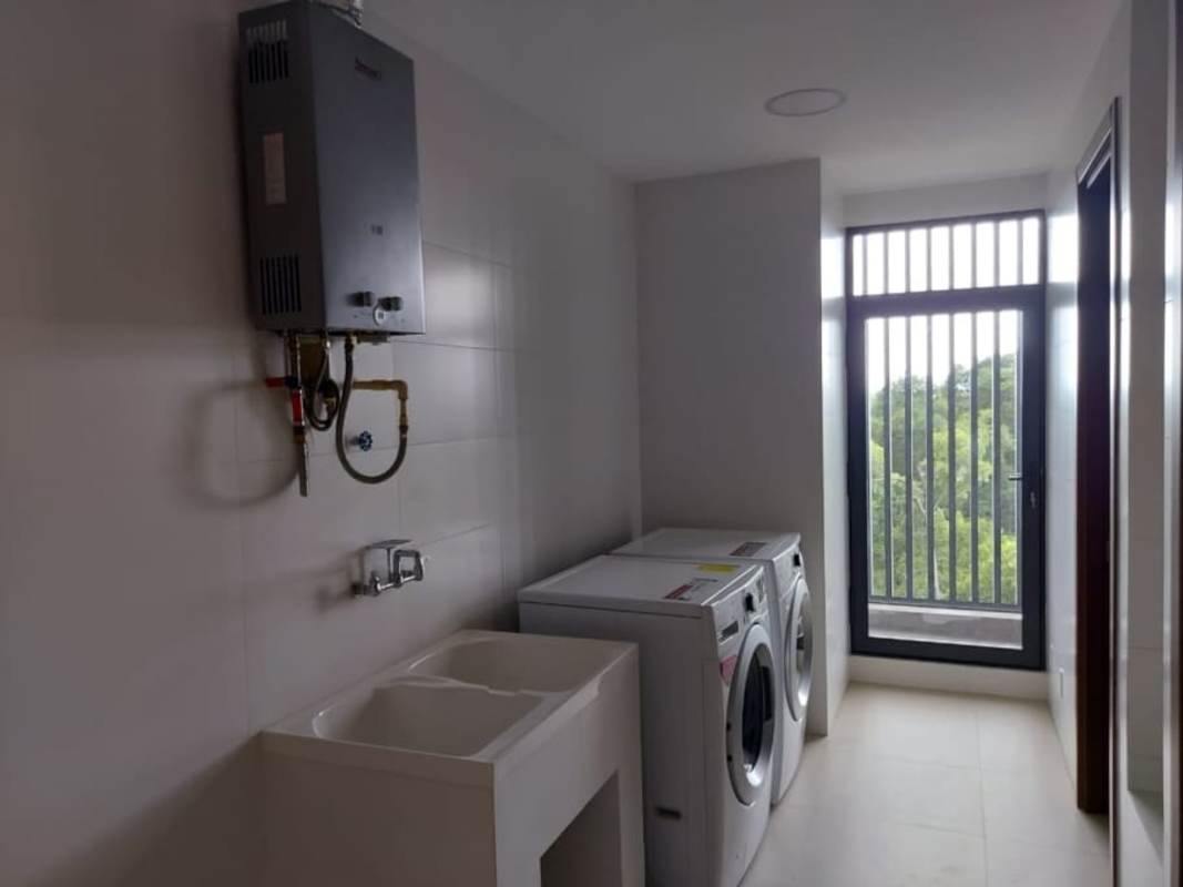 Floor-to-ceiling windows offering golf course and skyline views modern Panama apartment