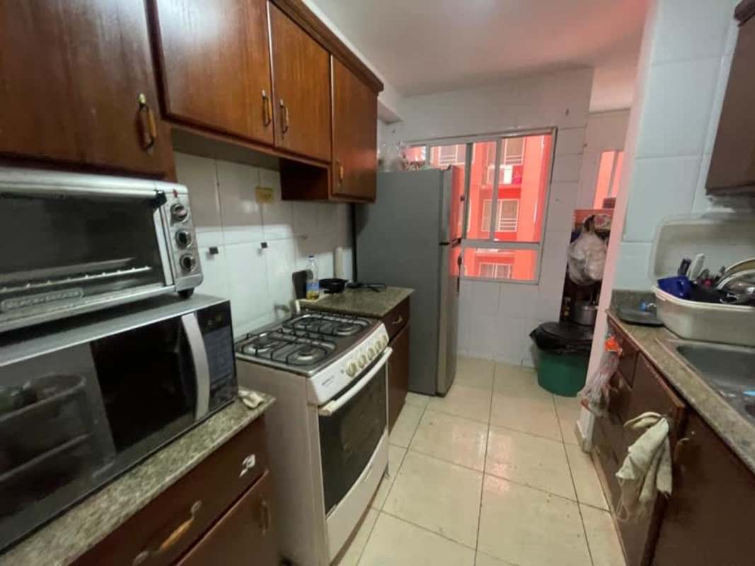 Narrow traditional kitchen with granite countertop, cabinets, appliances in PH Royal Hills Tower II Panama