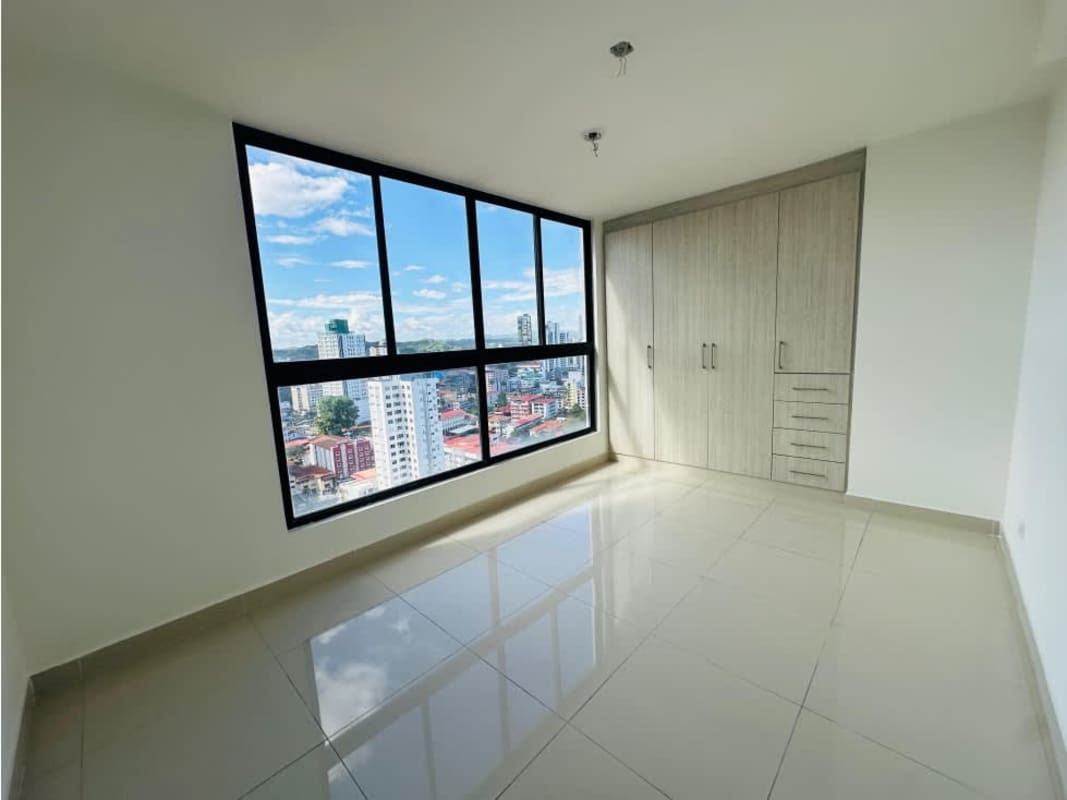 Bedroom with panoramic windows offering city view in PH Balboa Bay Panama City