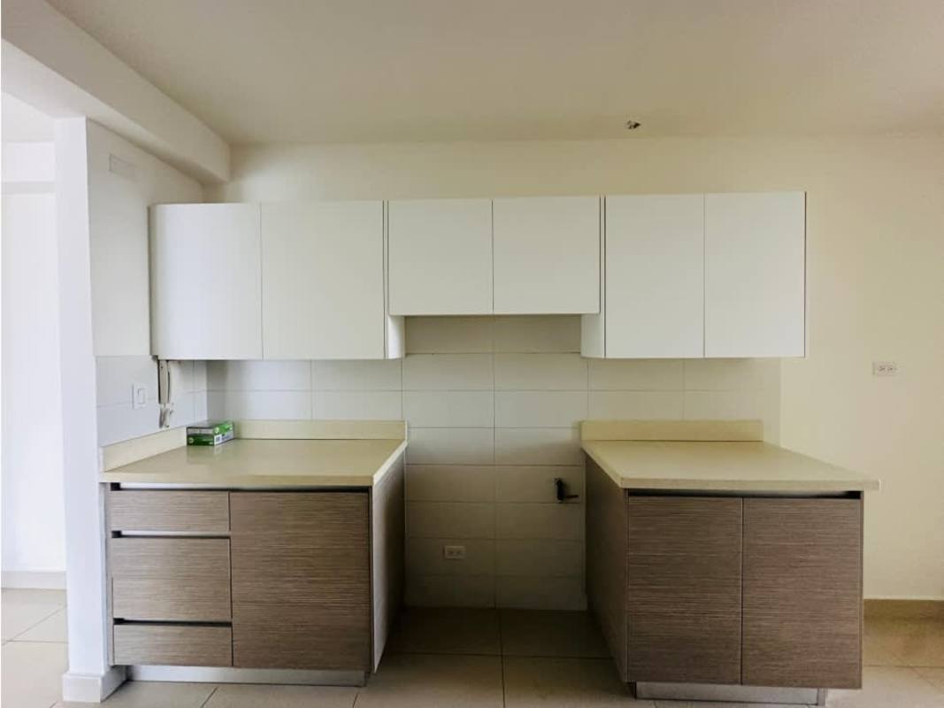 Modern minimalist kitchen with L-shaped counters and light cabinetry PH Balboa Bay Panama City
