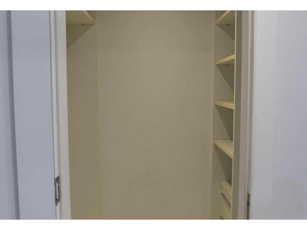 Bathroom with double sinks and glass shower in Yoo Panama apartment