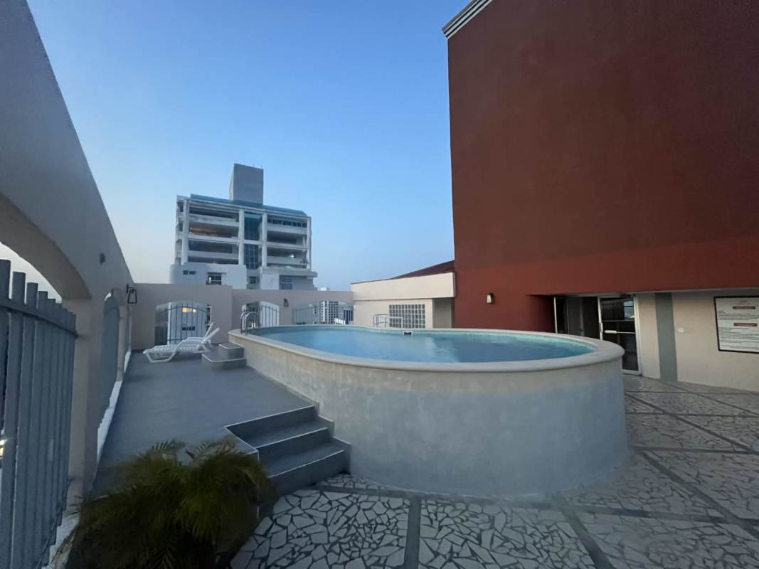 Circular elevated swimming pool on rooftop of PH Villa Nuova with mosaic tiles and cityscape view Panama City