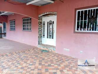 Exterior main porch pink wall tiled floor white door rental house David Panama