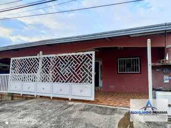 Exterior with gated porch, burgundy walls and tiled terrace rental house David Panama