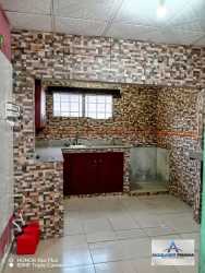 Kitchen interior with L-shape mahogany cabinets mosaic tile backsplash David rental