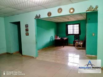 Large unfurnished living area with teal walls tiled floor rental house David