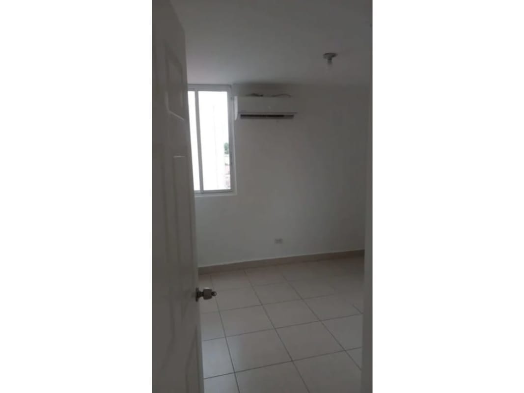 Exterior view white mid-rise gated apartment Residencial Las Palmeras Rio Abajo Panama City