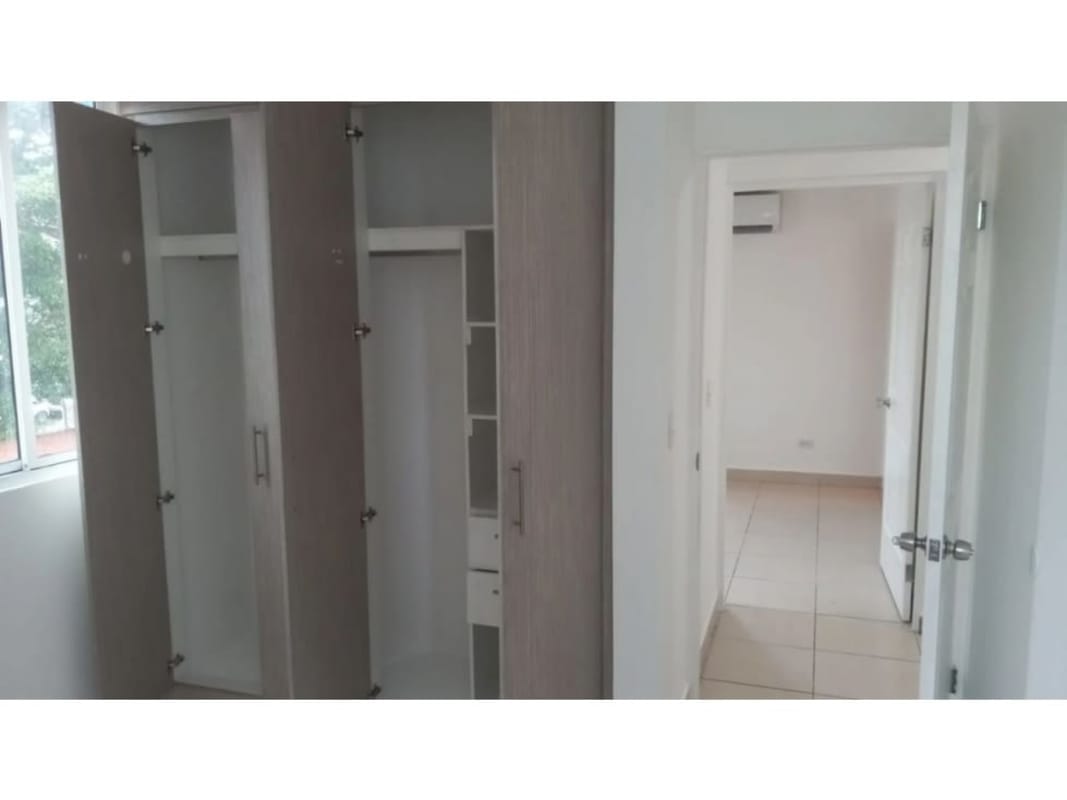 Minimalist bedroom with tiled floor, built-in closet and window at Las Palmeras Rio Abajo