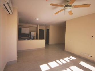 Outdoor swimming pool surrounded by gardens and lounge chairs at PH River Valley Panama Pacifico