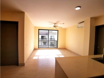 Fitted kitchen with breakfast bar in PH River Valley Panama Pacifico apartment with modern tile flooring