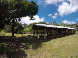 Rustic open shelter on large grassy yard with mature trees Cerro Azul Panama
