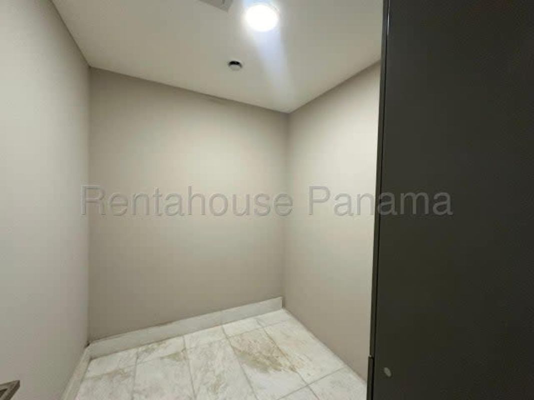 Spacious bathroom with double sink vanity, bathtub, and marble walls at The Residences Punta Pacífica