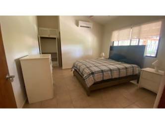 Bedroom with large window, AC, closet space overlooking garden in Coronado Panama home