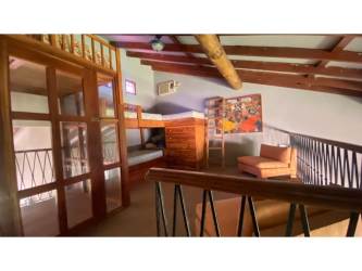 Loft bedroom with bunk beds, exposed wood beams Coronado Estate Panama