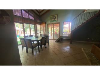 Living room with exposed wood beams, tile flooring, staircase Coronado Golf Estate