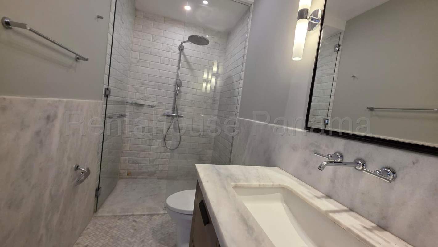 Bright master bedroom with floor-to-ceiling windows overlooking Santa Maria Golf Panama City