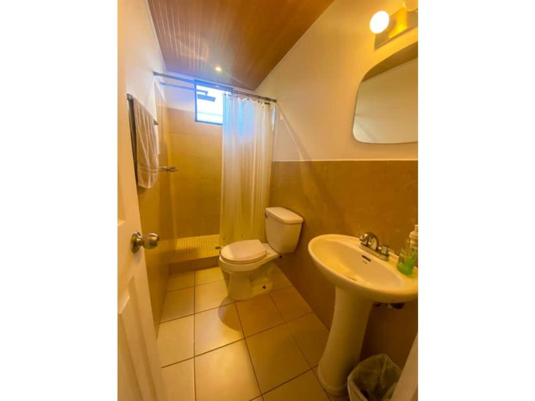 Bathroom with walk-in shower, wood ceiling, pedestal sink PH Saramel Parque Lefevre Panama