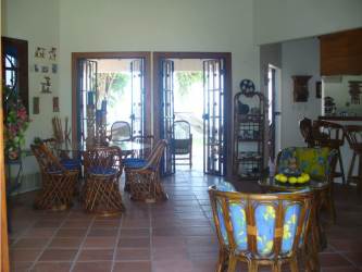 Rustic tropical porch with hammock and garden view at Panama beachfront villa