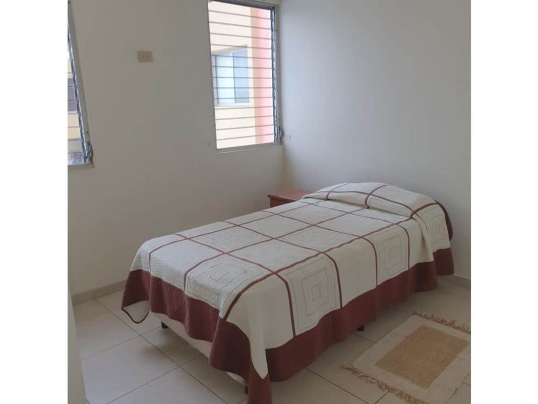 Small bathroom with walk-in shower tile walls Panama City apartment