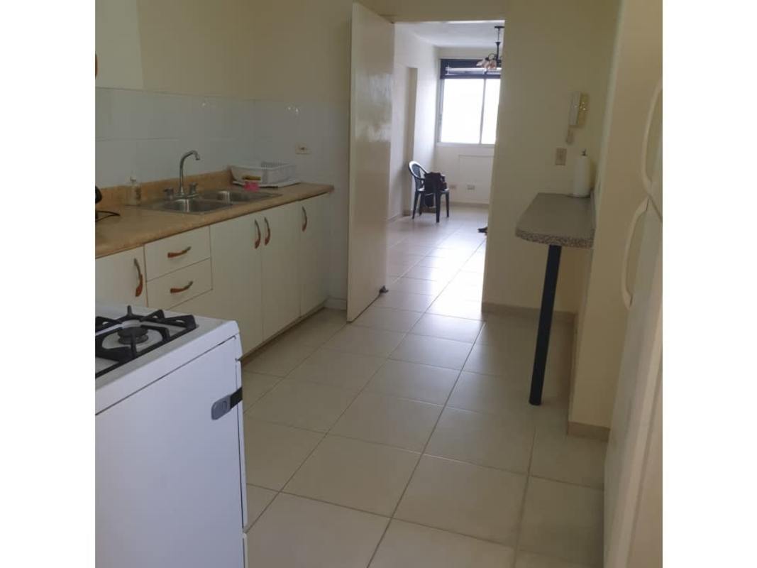 Bright kitchen with counter stove window Villa de las Fuentes Panama