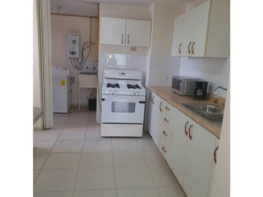 Kitchen with gas stove microwave laundry hooks PH Victory Towers apartment for sale